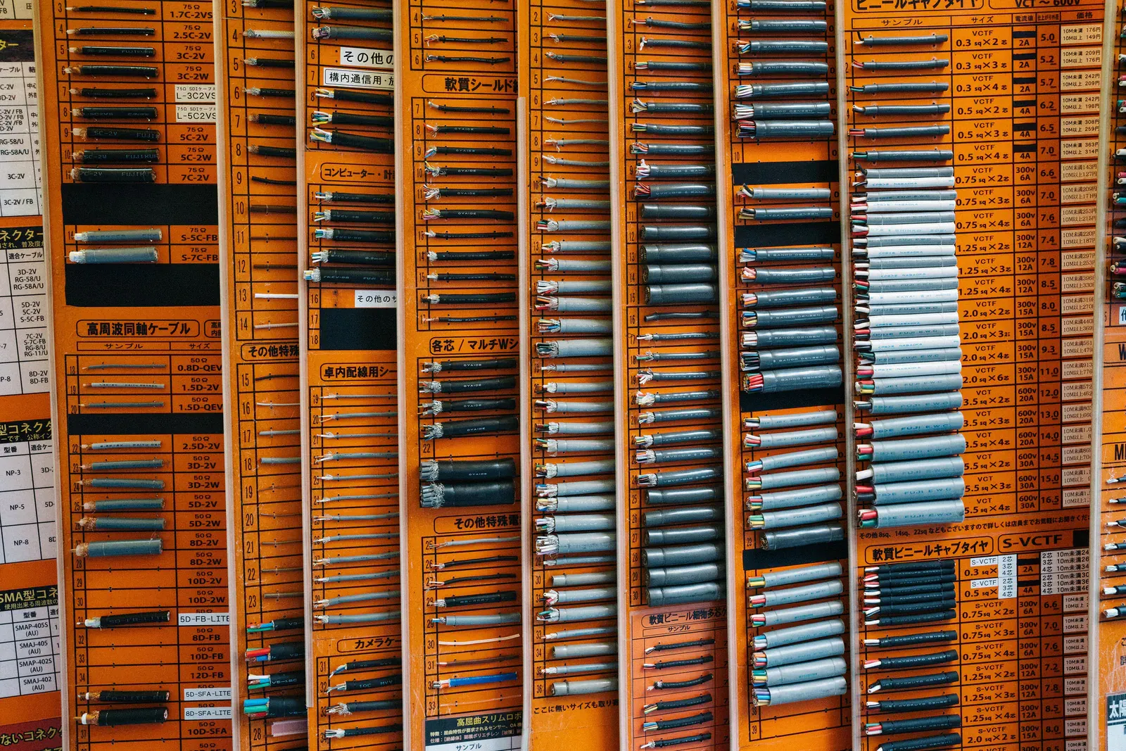 Wall of orange parts drawers in an electronics shop