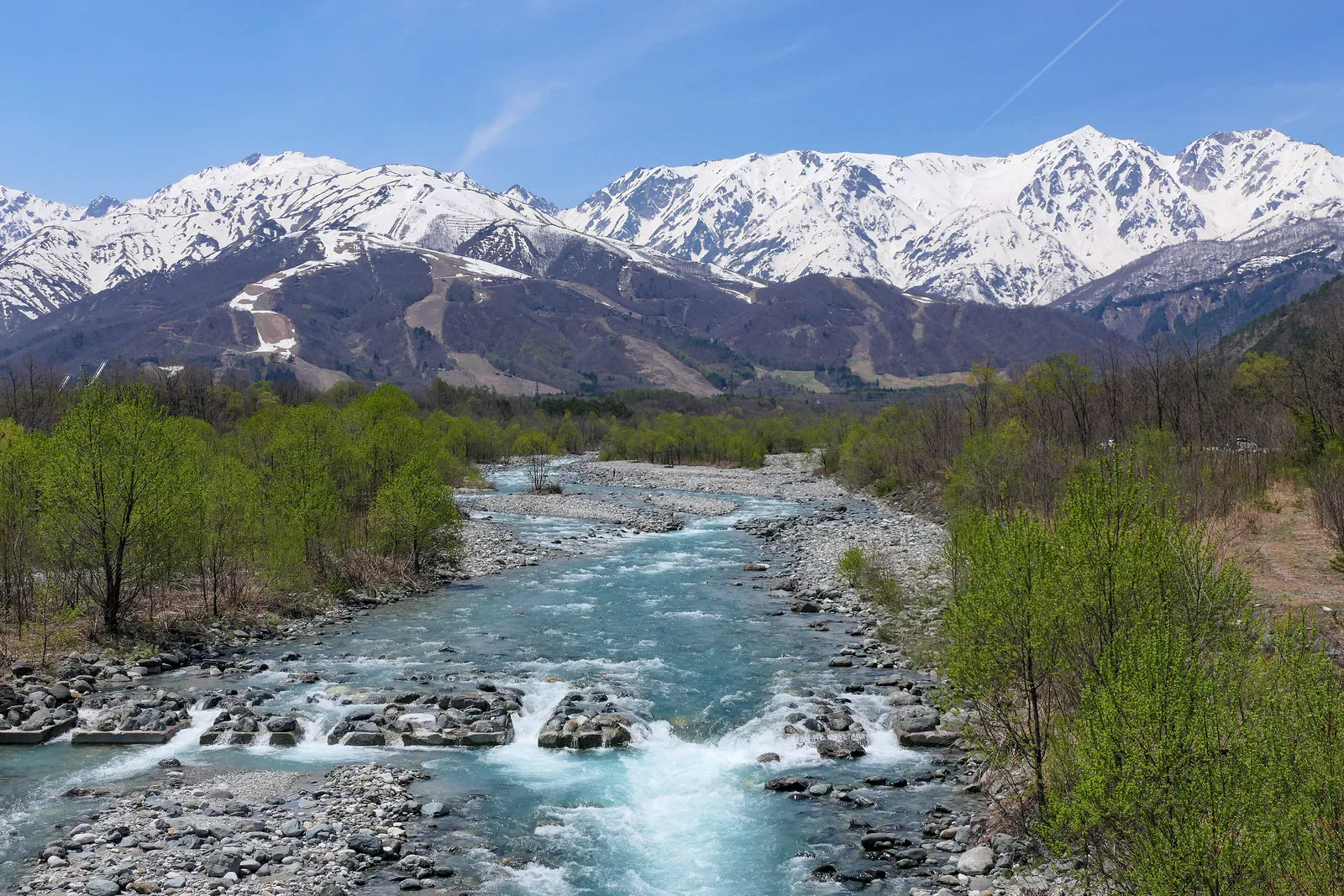 Snowy peaks above a mountain river near Hakuba