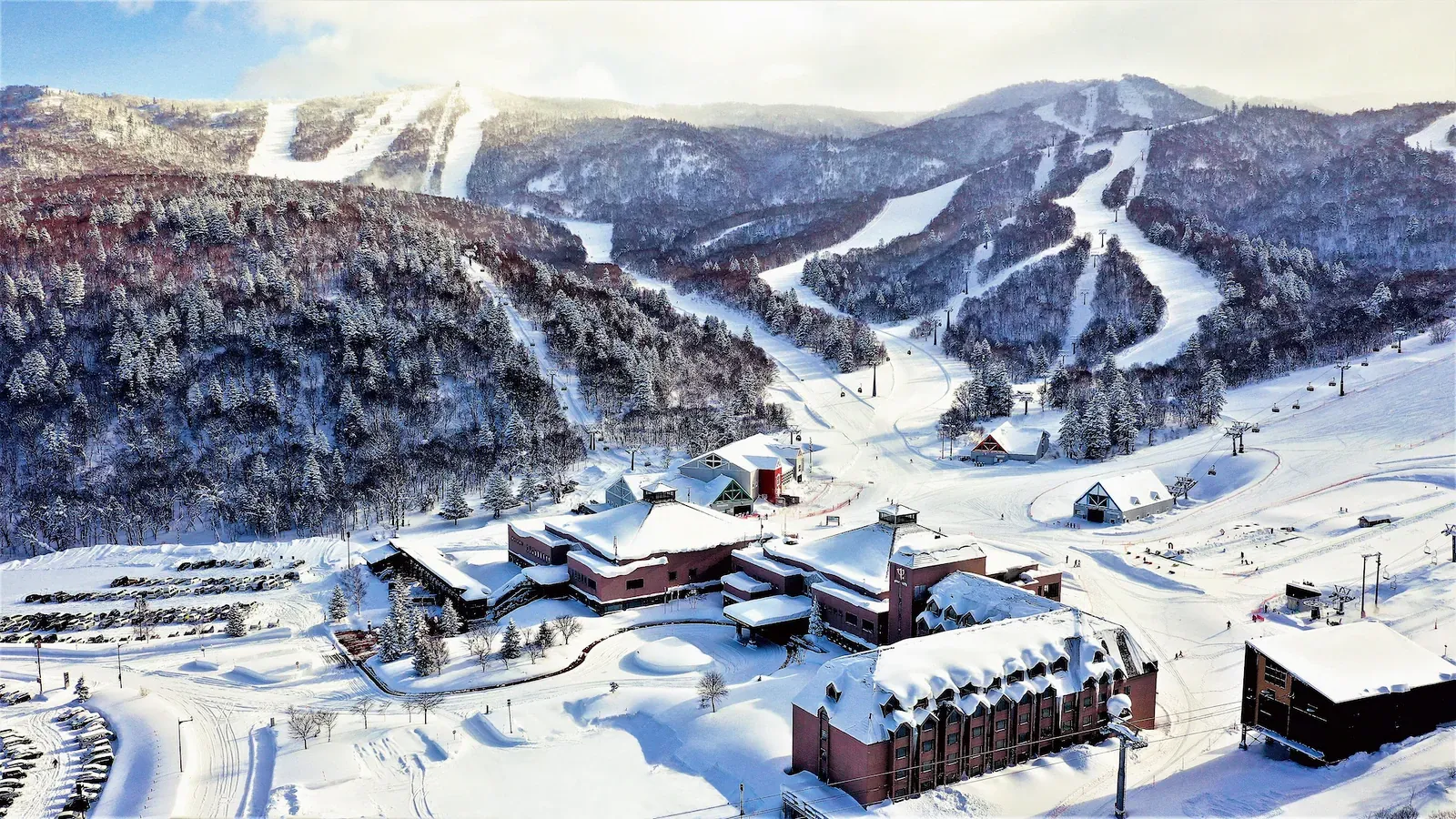 Ski resort base below snowy slopes