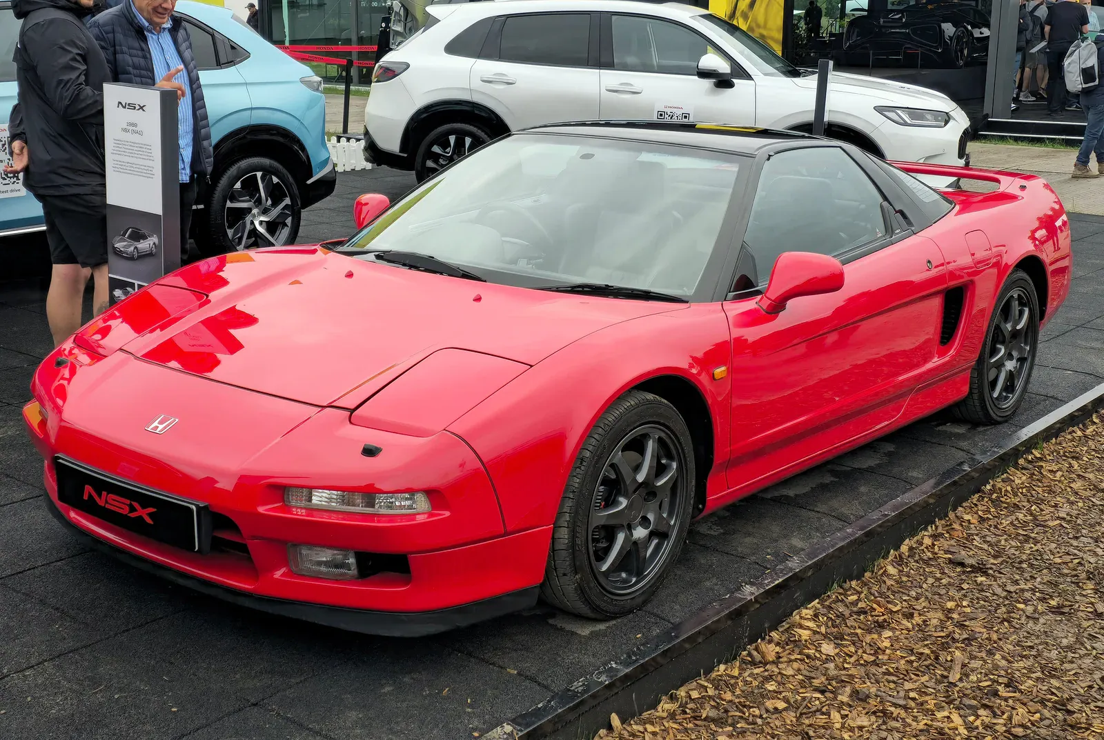 Red first-generation Honda NSX on display at a car show