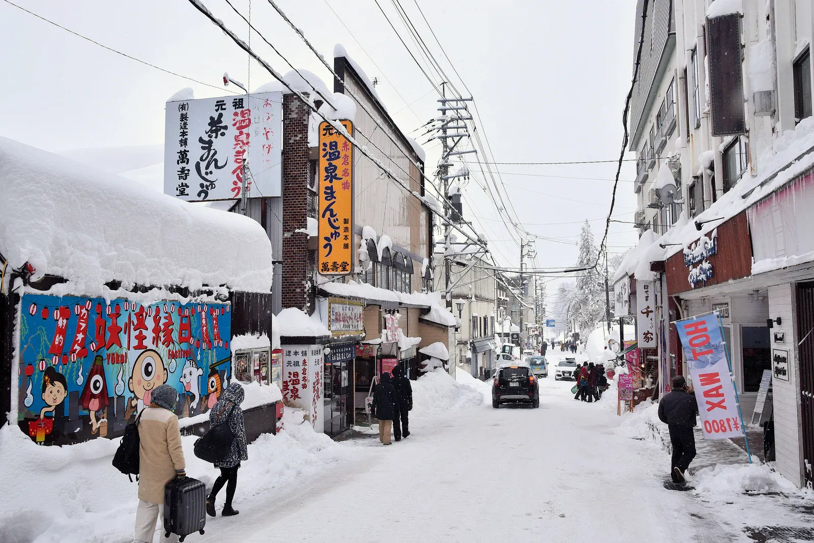 Snowy street with shops in Myoko