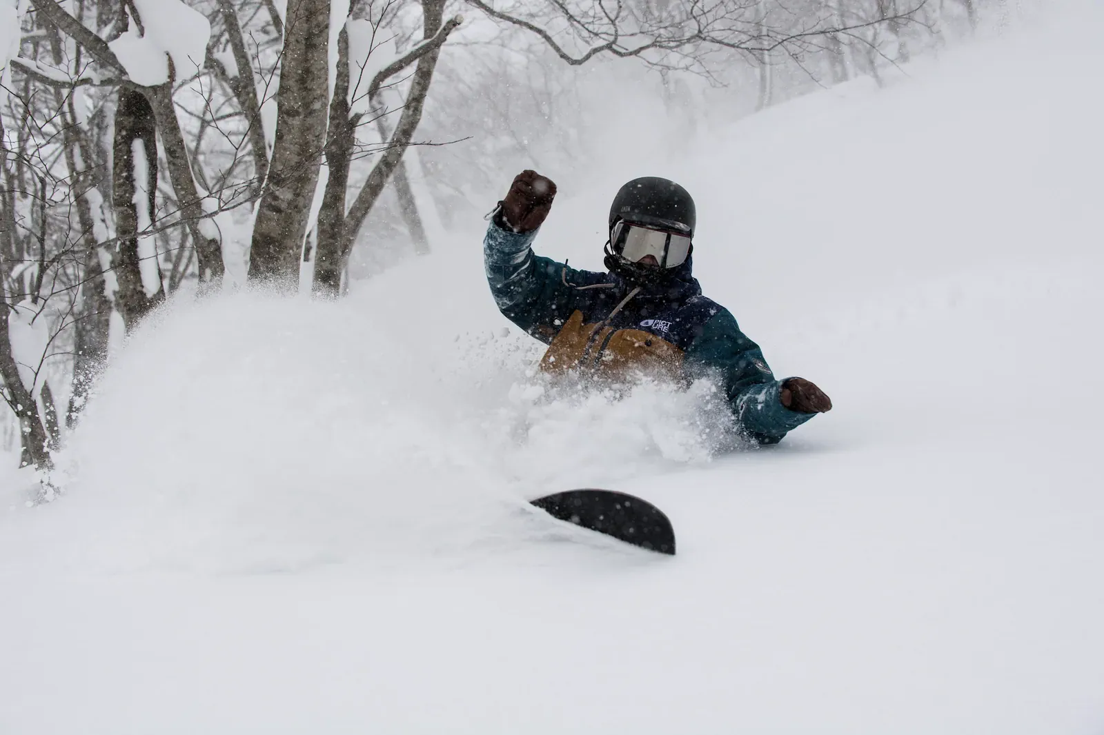 Snowboarder in a powder spray
