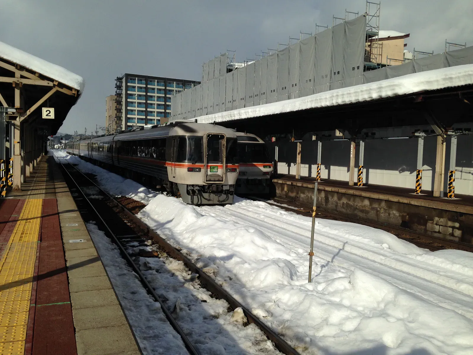 Diesel train at a snowy station platform