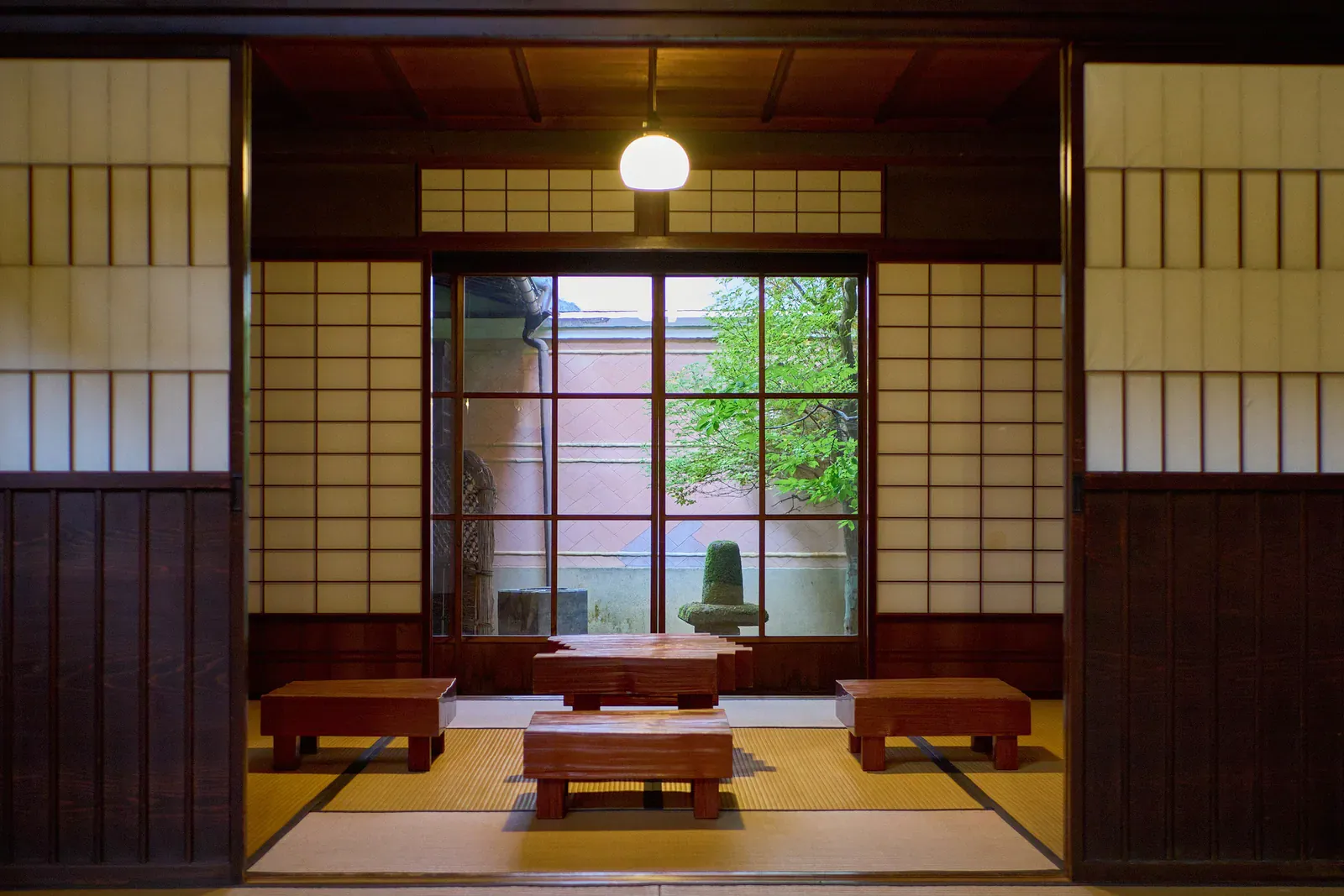 Traditional tatami room with low tables and a window onto a garden