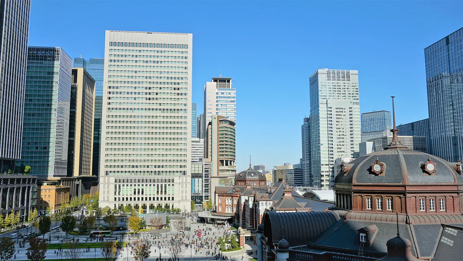 Tokyo office towers behind a domed red-brick building
